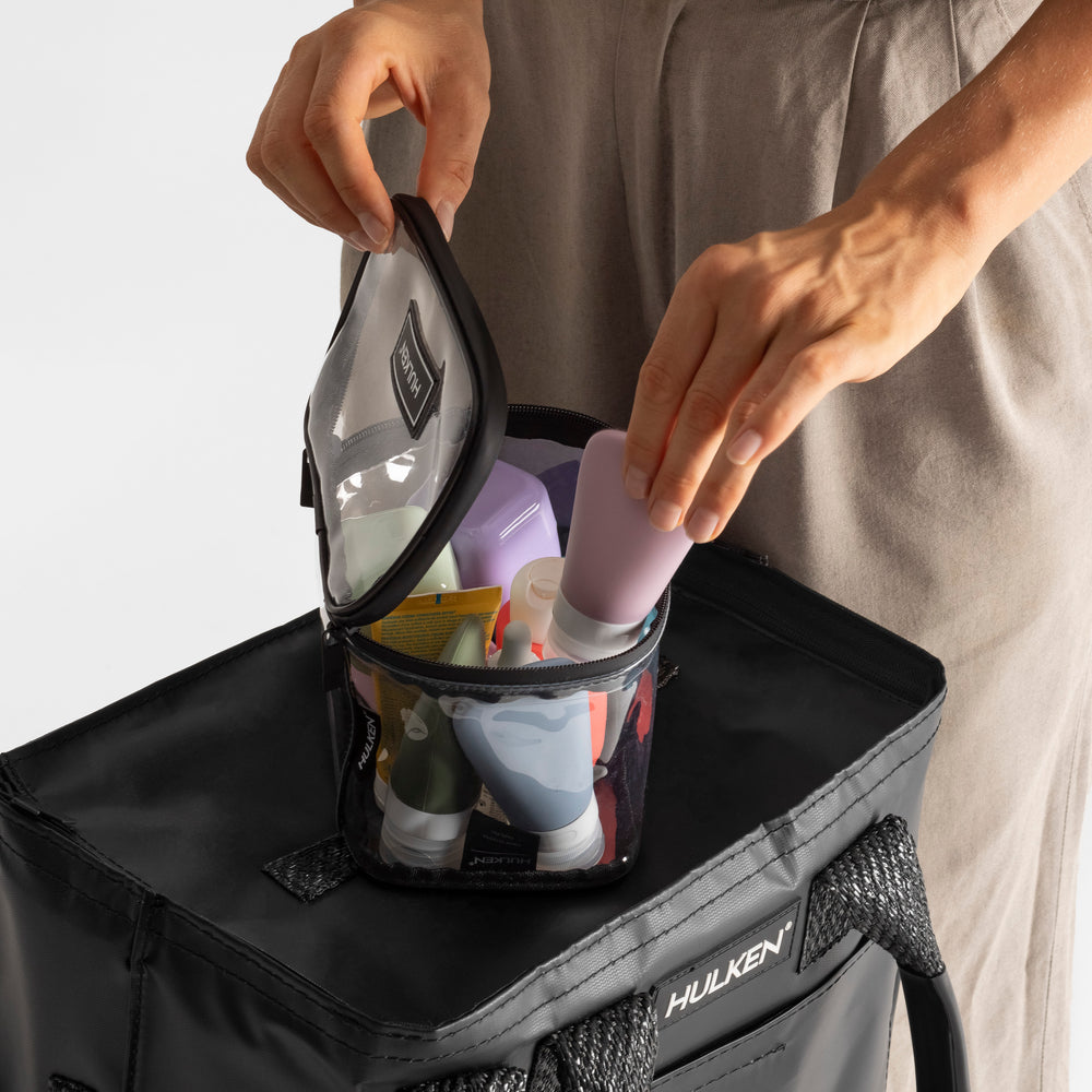 Person opening a black packing cube