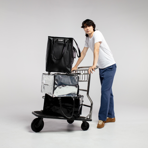 A person pushing a cart with multiple Hulken bags