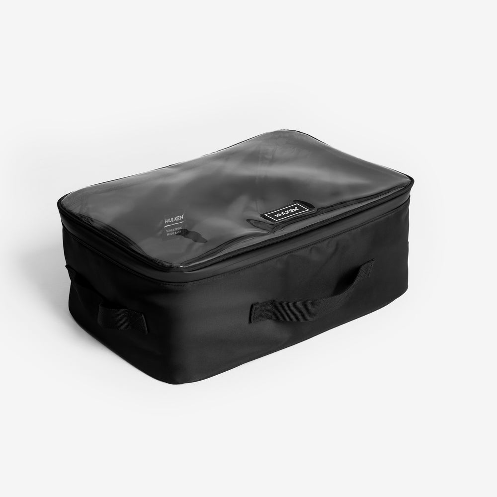 Black travel case with a clear top section on a white background