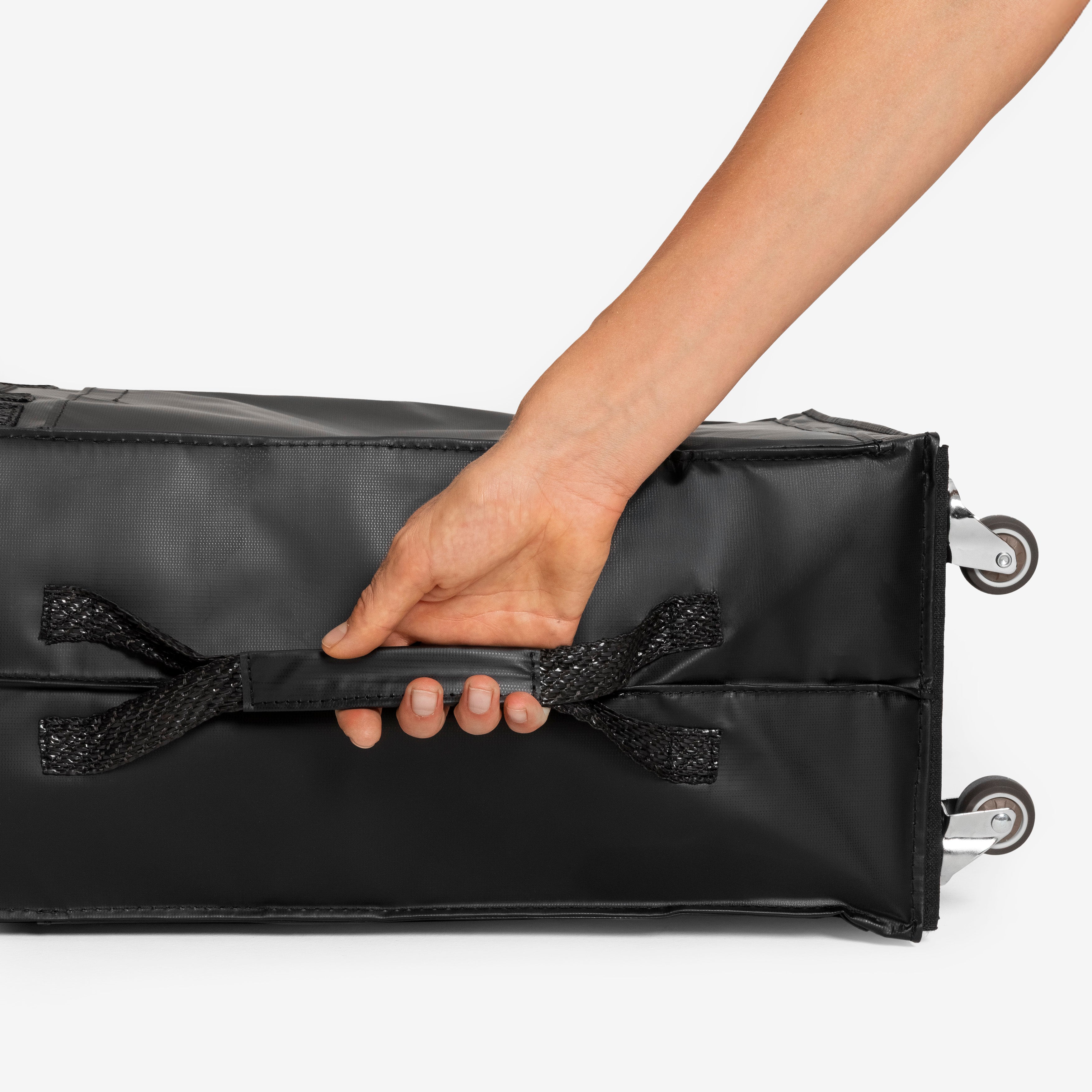 Hand holding a black carry-on