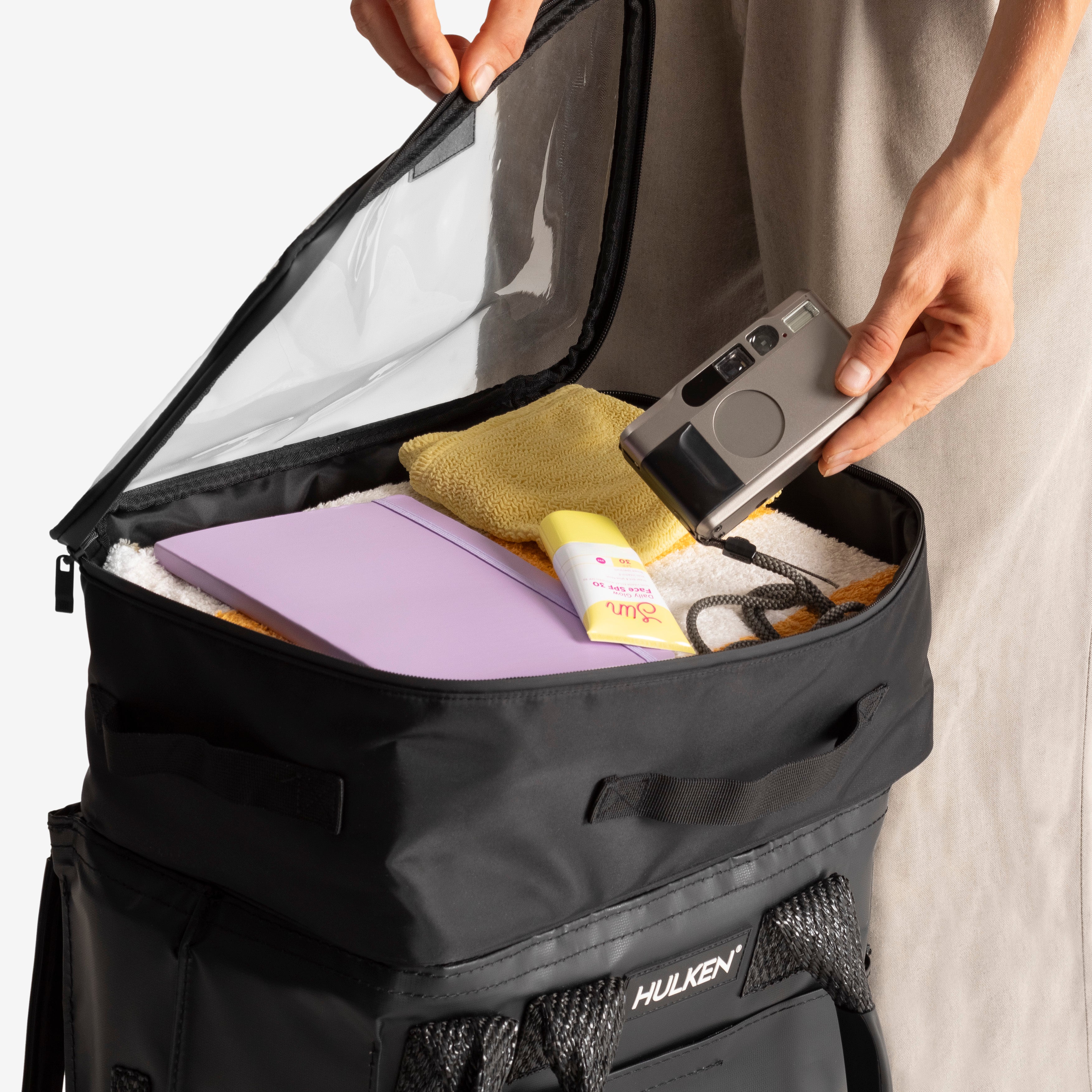 Person organizing items into a black packing set