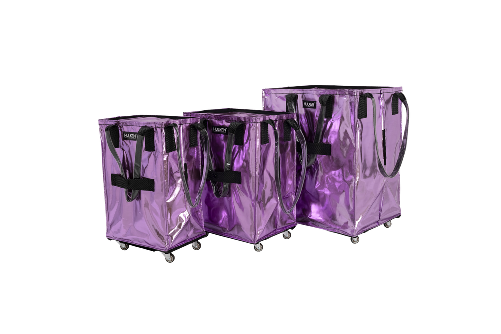 Three lilac transparent shopping carts with wheels on a white background