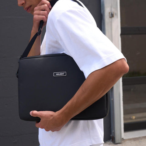 Black Hulken laptop bag worn on a person's shoulder